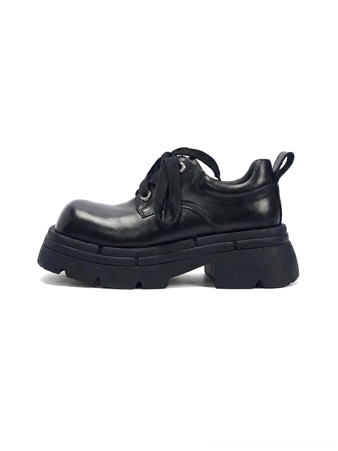 Black chunky platform derby shoes with glossy horsehide upper, rounded toe, rope laces, rear pull tab, detachable plush charm, and thick lug sole shown in a three-quarter side view