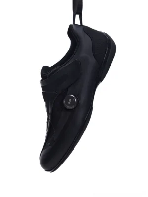 Black dial-closure low-profile racing sneakers in left lateral three-quarter view with layered nylon panels and streamlined matte finish