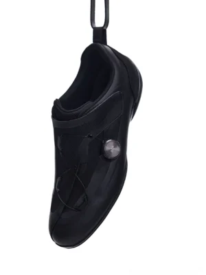 Black low-profile racing sneaker with adjustable dial closure elastic lacing and sleek technical streetwear upper front three-quarter view