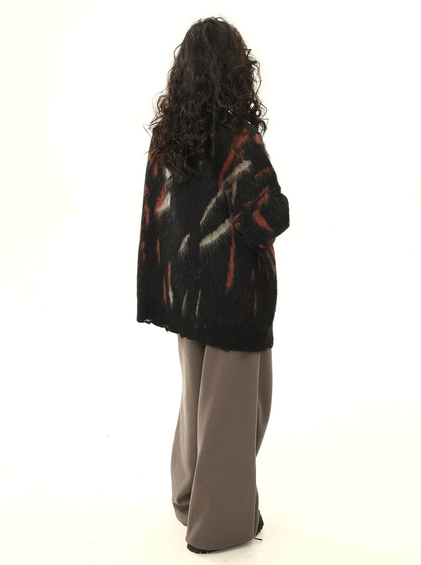 Back view of black distressed abstract print oversized sweater with all-over graffiti-inspired design