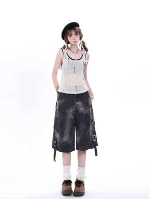 Model wearing black distressed denim cargo Bermuda shorts in a Y2K Korean streetwear outfit with a beret, knit tank top, wide-leg cut, bleached pattern, and adjustable buckle straps