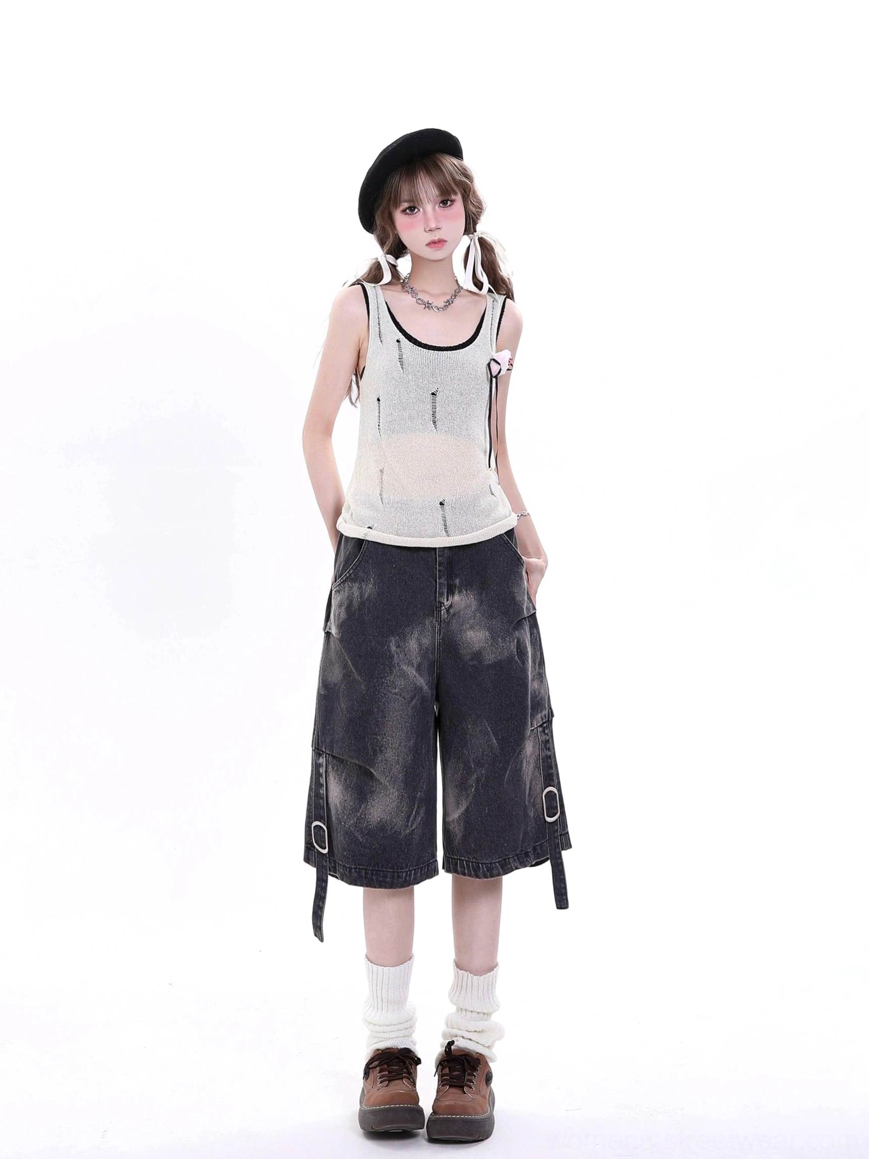 Model wearing black distressed denim cargo Bermuda shorts in a Y2K Korean streetwear outfit with a beret, knit tank top, wide-leg cut, bleached pattern, and adjustable buckle straps