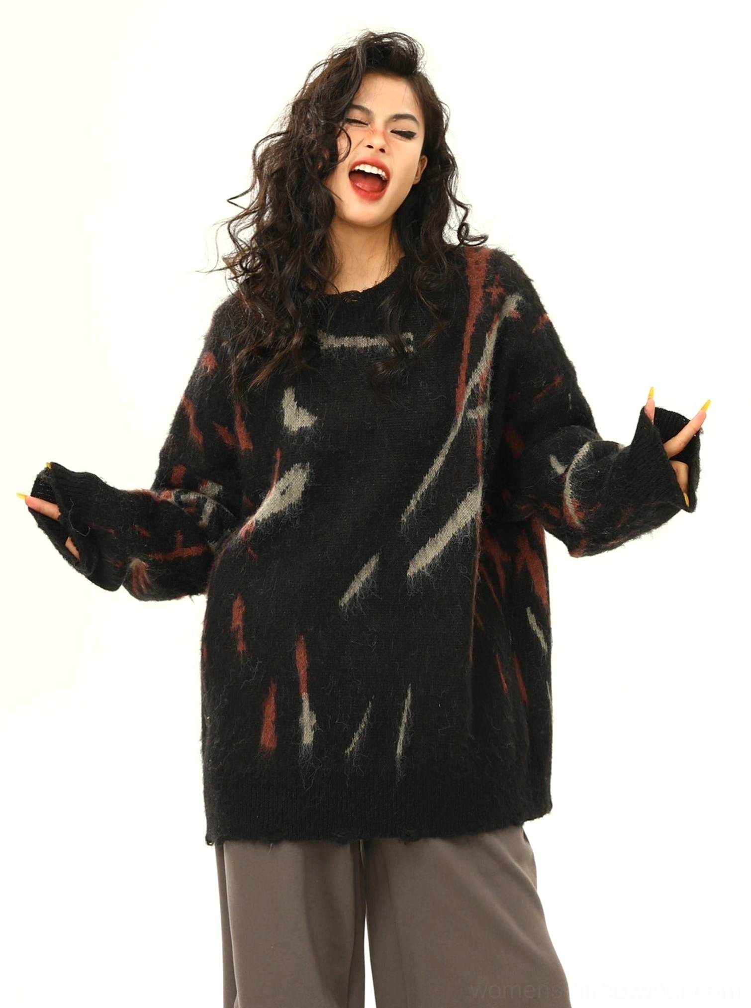 Black distressed graffiti print oversized sweater showing frayed cuffs and full abstract streetwear graphic