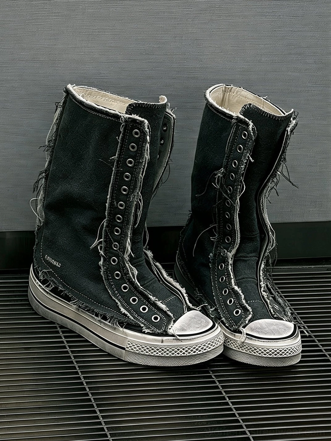 Pair of black distressed high-top canvas platform boots with frayed lace eyelet trim and white rubber soles