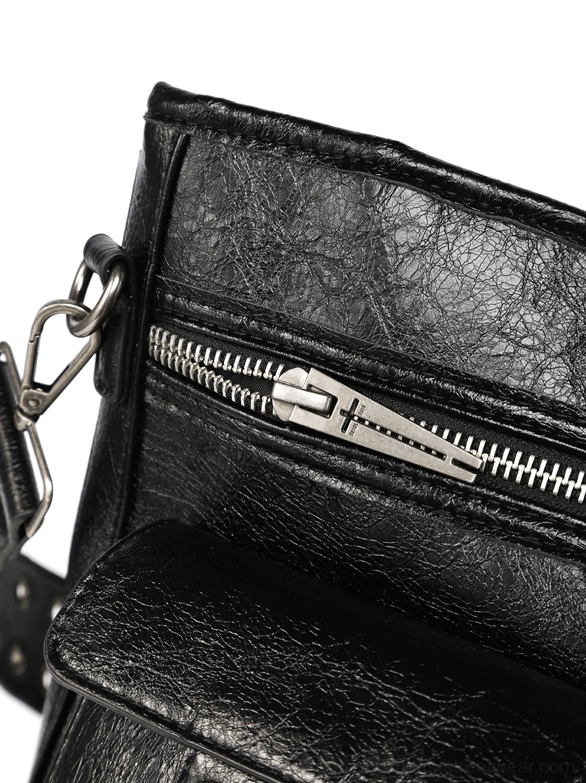 Close-up of black distressed leather tote bag zipper closure, silver metal hardware, and exterior pocket construction