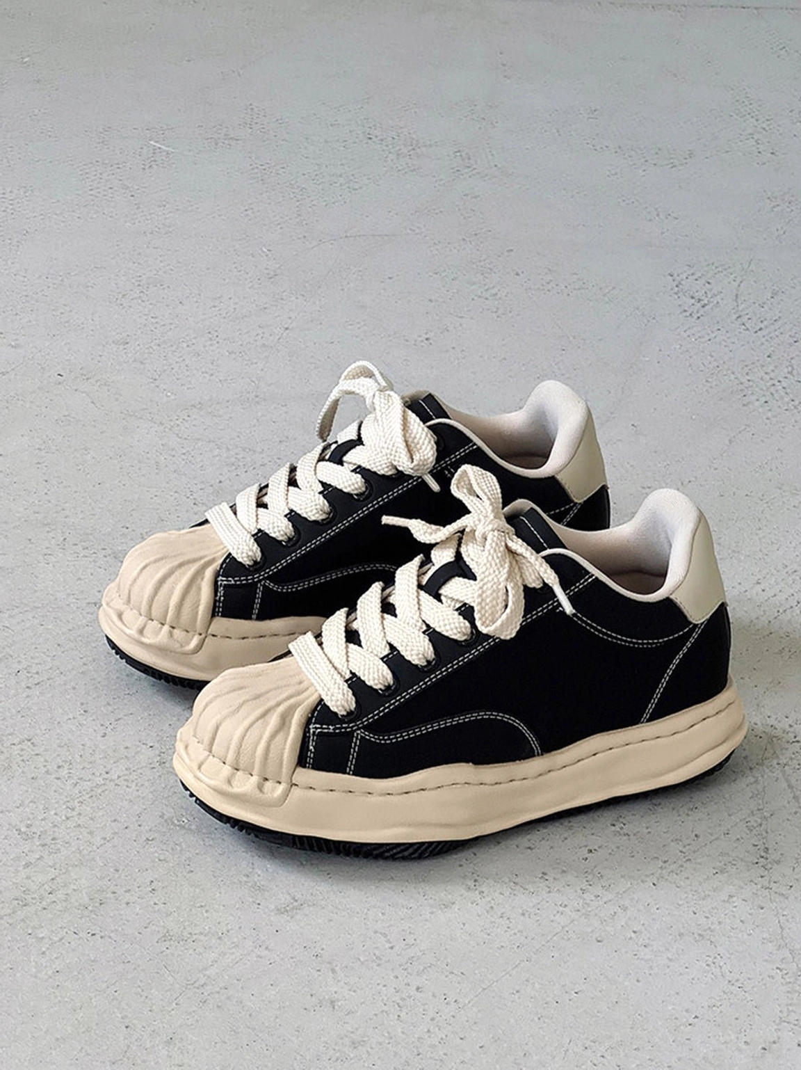 Black distressed low-top platform sneakers designed for Korean street style, Acubi fashion, and everyday city wear