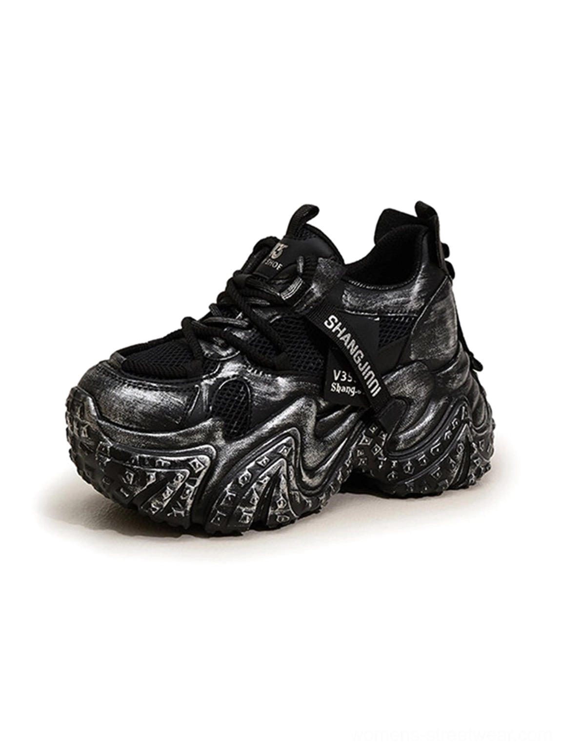 Black distressed platform dad sneakers side three-quarter close-up showing woven webbing mesh panels and marbled sole