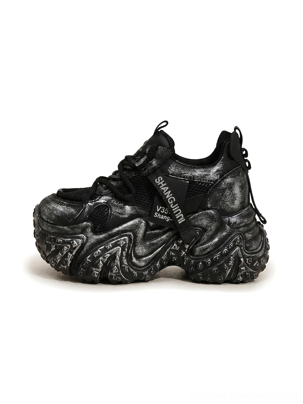 Black distressed sculptural platform dad sneakers with layered mesh upper and marbled chunky sole front side view
