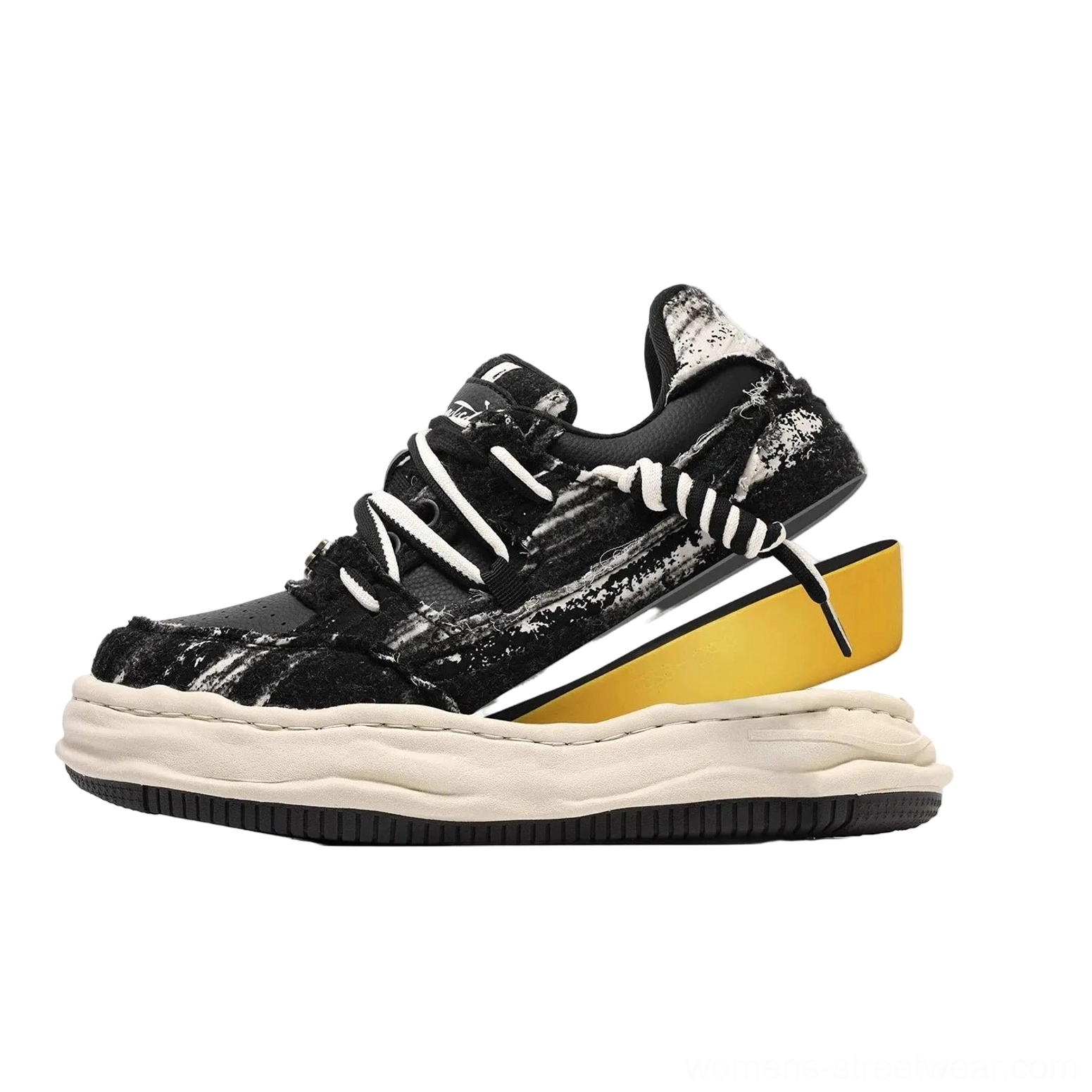 Black distressed thick sole skate sneakers with contrasting hidden yellow midsole layer and dual layer laces shown in a front three quarter product view