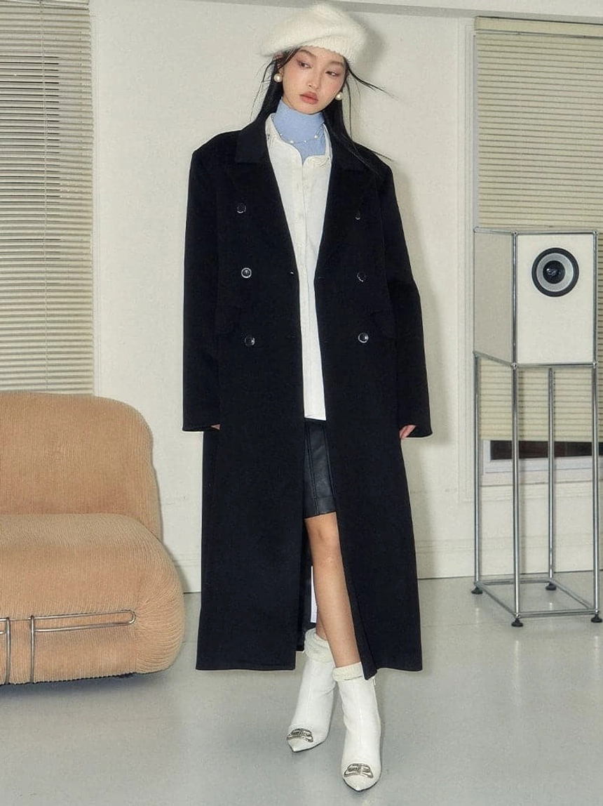 Black double-breasted wool long coat layered for a Seoul-inspired winter streetwear outfit