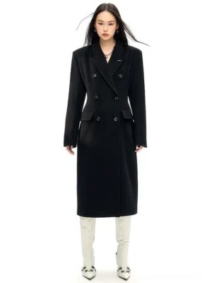 Black double-breasted wool long coat with slim waist tailoring shown in a full front studio view