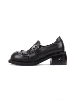 Black double-buckle block-heel loafers shown in left side profile with polished leather-look upper, silver buckles, rounded toe, and chunky 5.5 cm heel