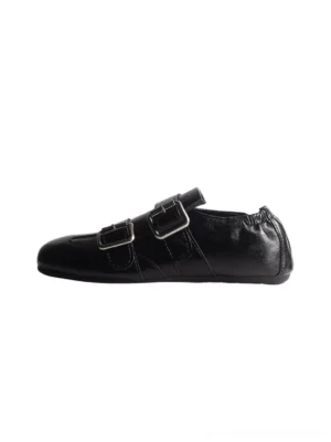 Black double-buckle leather loafer flat side profile with silver hardware and softly squared toe
