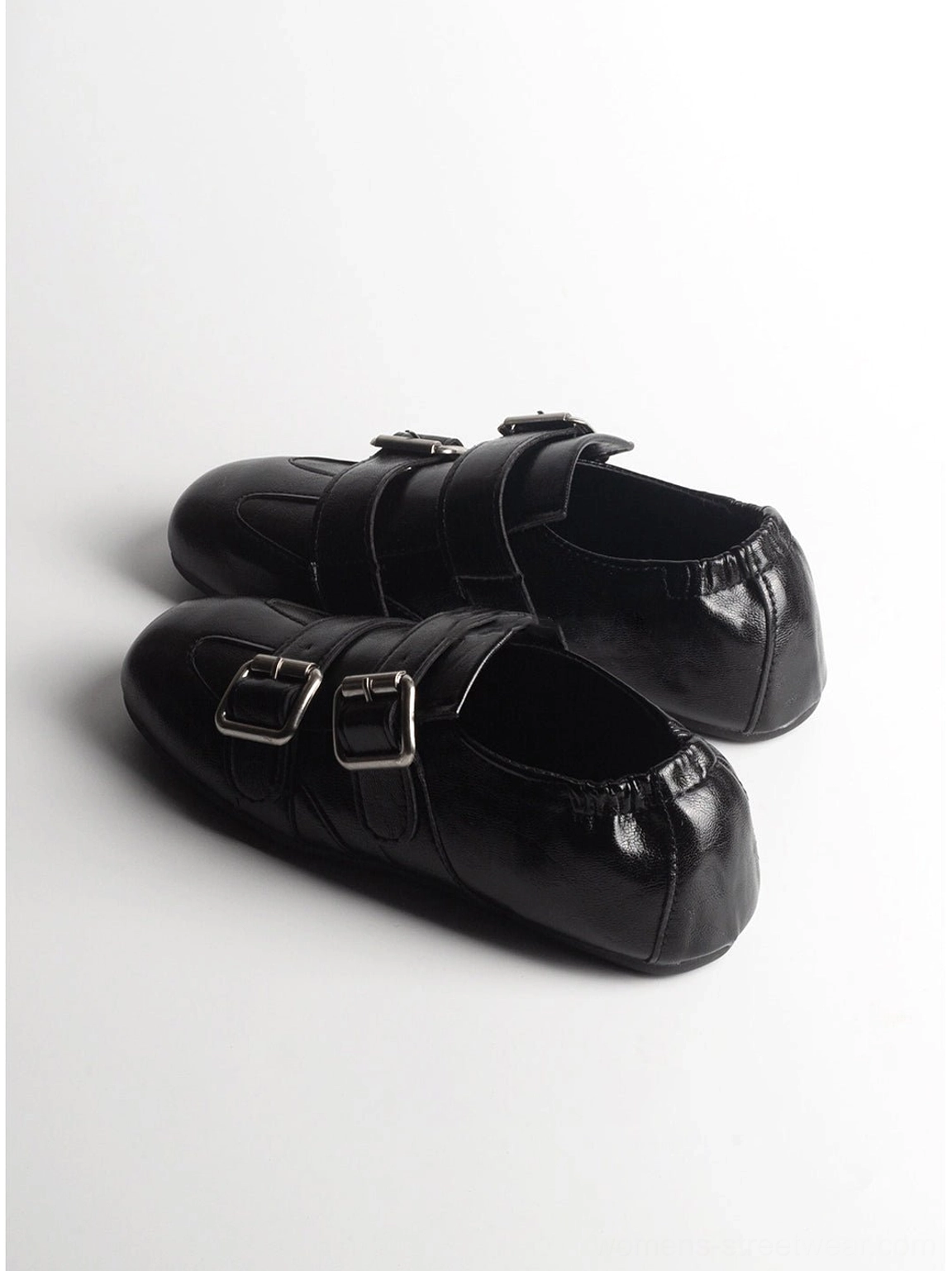 Pair of black double-buckle leather loafers with polished finish and silver buckle straps