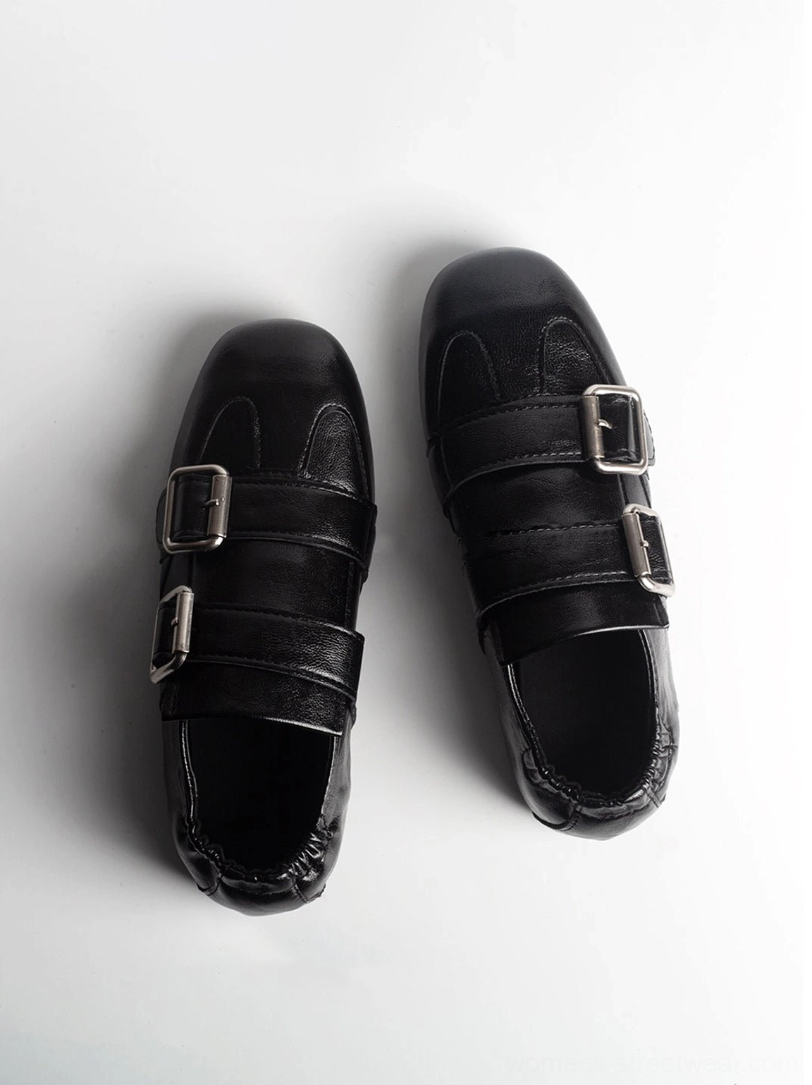 Top view of black leather loafers with double silver buckles square toe and elasticized heel