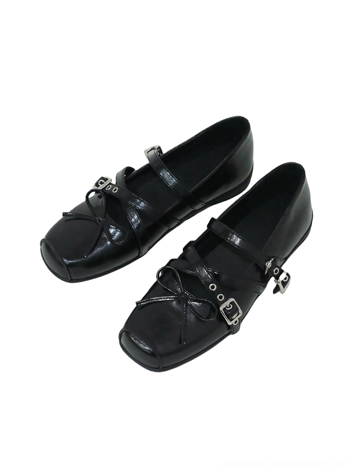 Top-down flat lay of black double-strap Mary Jane flats with square toes, decorative bows, silver adjustable buckles, visible insoles, and rubber soles