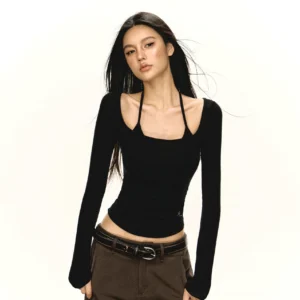 Black double strap scoop neck fitted Y2K long sleeve crop top styled with brown low-rise pants in front studio view