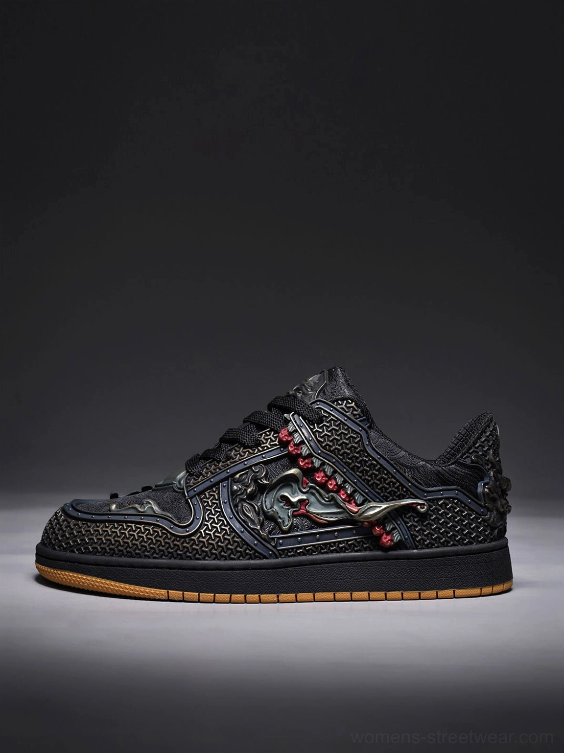 Side profile of a black dragon embroidered low-top sneaker with perforated black upper and contrast gum outsole