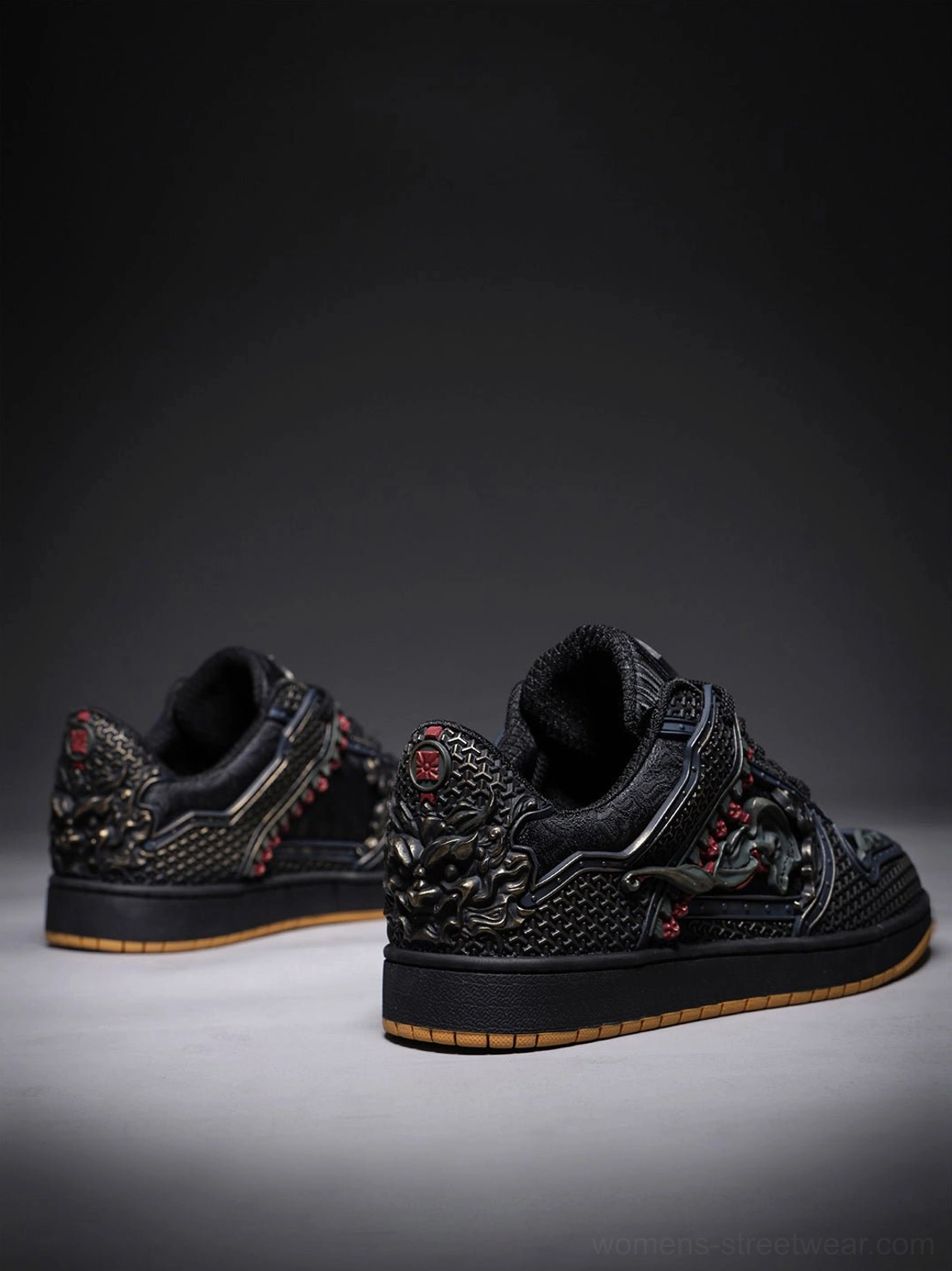 Rear three-quarter view of black dragon embroidered sneakers with sculpted heel ornaments and contrast gum outsole