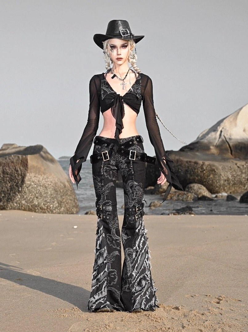 Front view of black dragon pattern flared denim jeans with a fitted waist, buckle belt, grey dragon graphics, and cowboy goth streetwear styling
