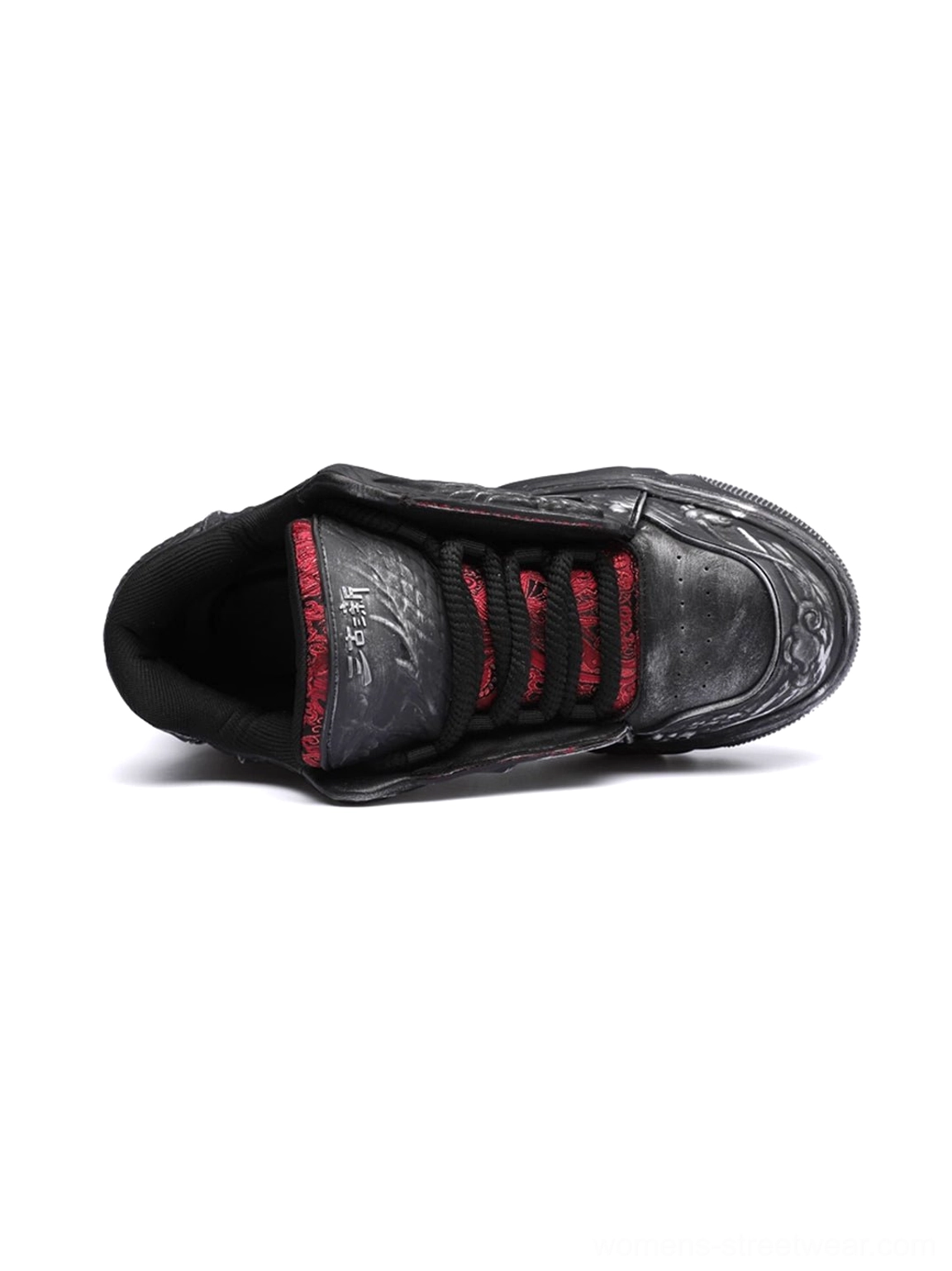 Single black dragon relief chunky platform sneaker shown from above with distressed black upper, red laces, red inner lining, and branded footbed