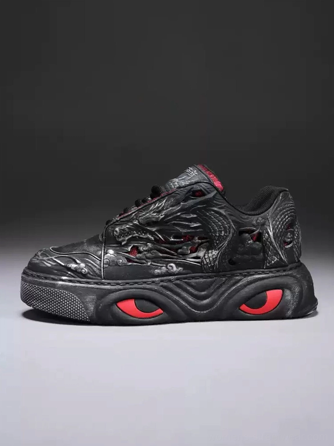 Black dragon relief chunky platform sneaker shown from the right side with embossed artwork, red sole details, and low-top lace-up construction