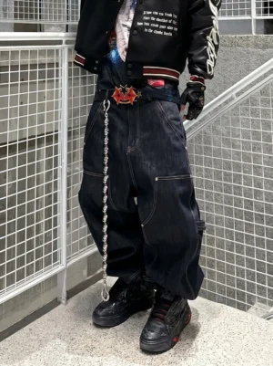 Black dragon relief platform sneakers styled with baggy dark denim, a varsity bomber jacket, and a metal wallet chain in an industrial streetwear outfit