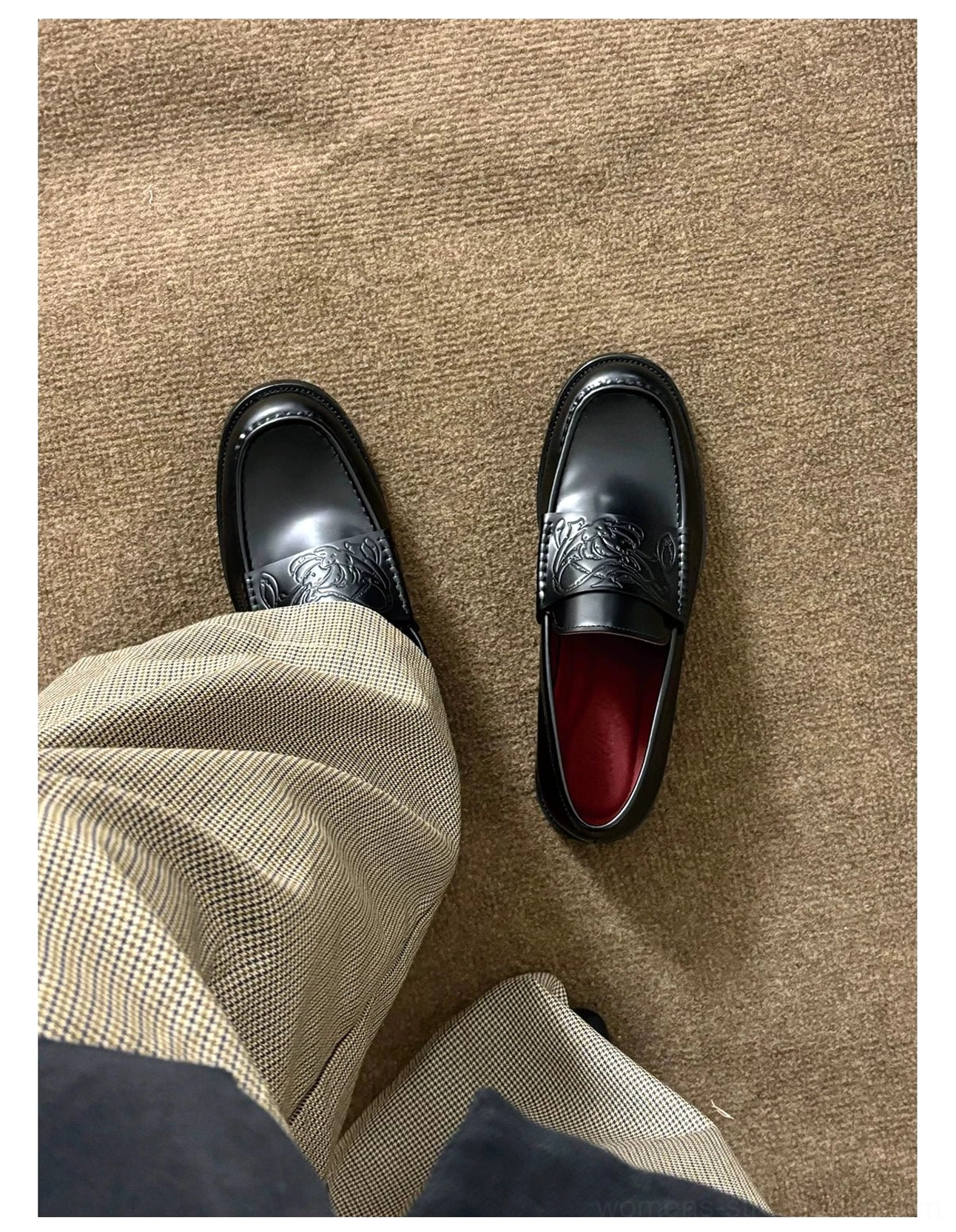 Black embossed leather loafers with square toes, polished leather finish, low stacked heels, and burgundy lining