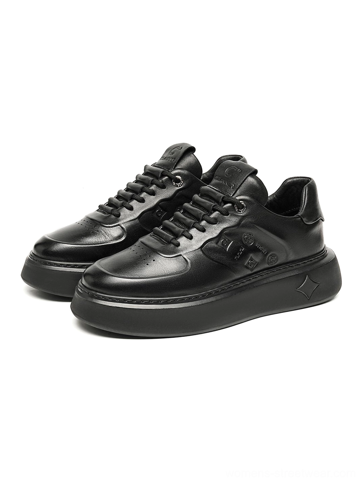 Front overhead view of all-black embossed platform low-top sneakers with minimalist streetwear silhouette