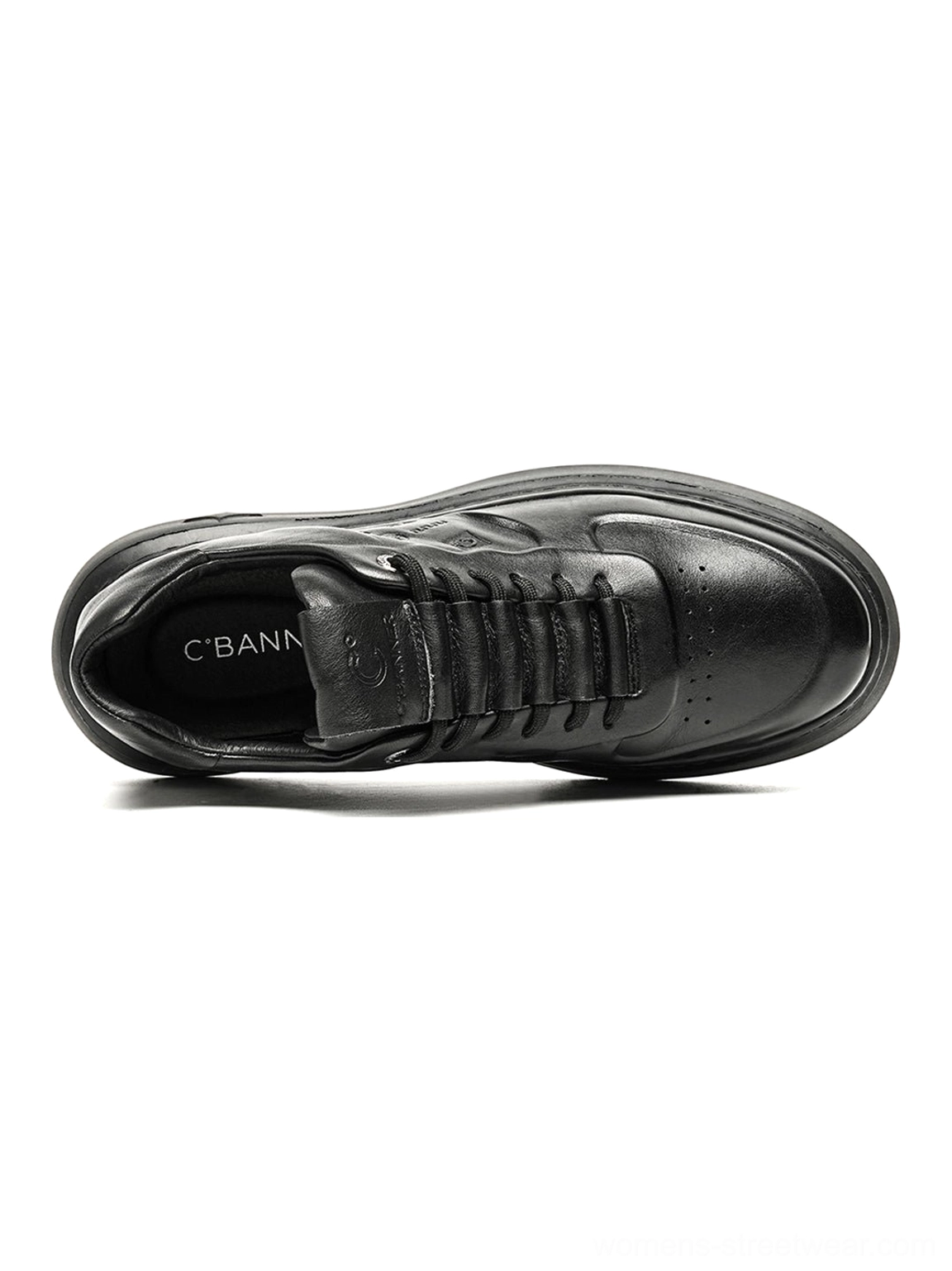 All-black embossed platform low-top sneakers close-up displaying the low-cut collar and layered upper panels