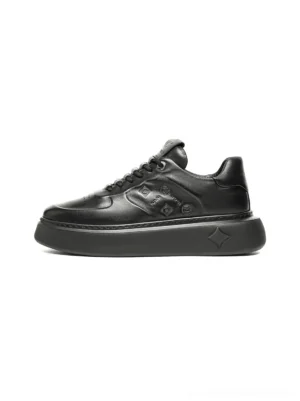 Black embossed platform low-top streetwear sneakers side top view on a white background