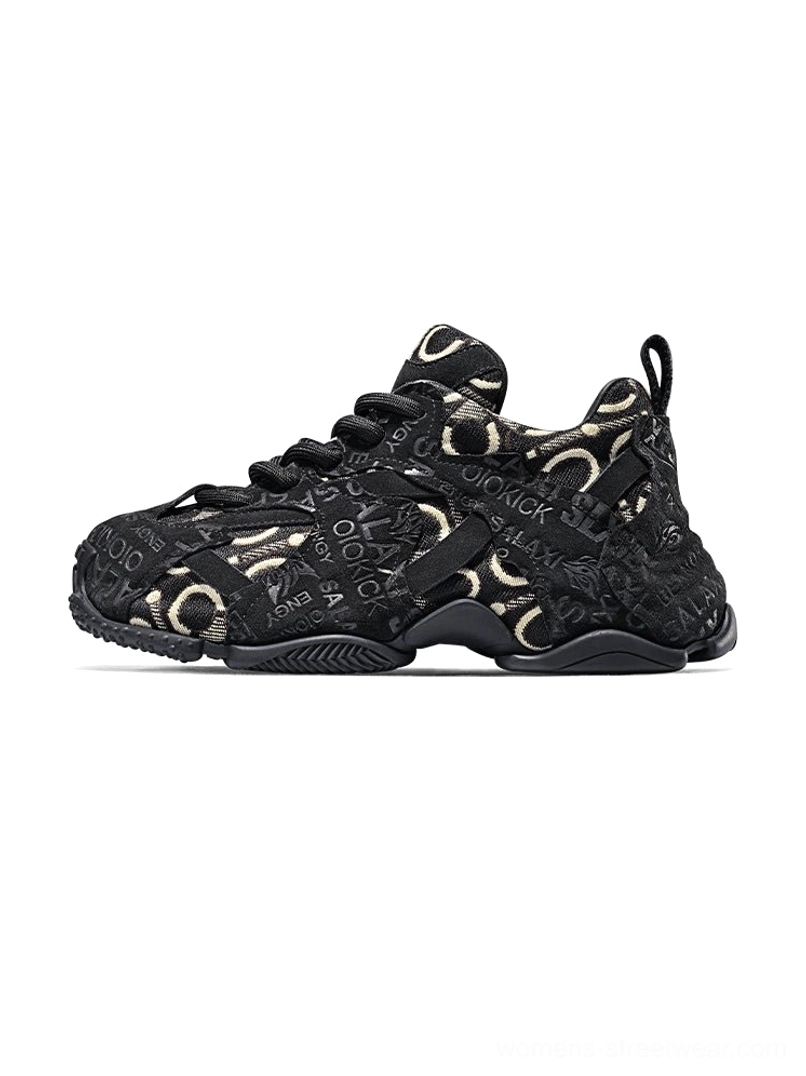 Black embroidered chunky dad sneakers with gold-tone monogram detailing, lace-up closure, layered athletic outsole and bold streetwear silhouette