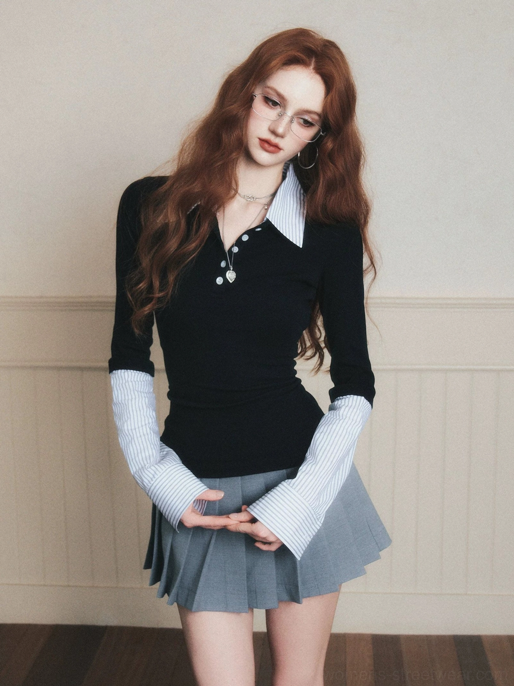 Black fake two-piece polo knit top with contrast striped collar and layered cuffs three-quarter side view