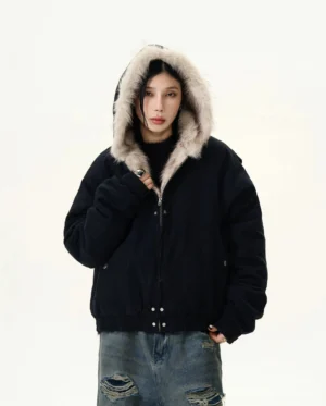 Black faux fur trim hooded cropped bomber jacket front view with hood up styled with ripped baggy denim