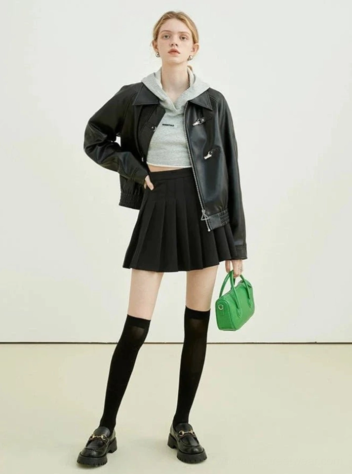 Full-body Korean streetwear outfit featuring black faux leather toggle zip jacket with pleated mini skirt and loafers