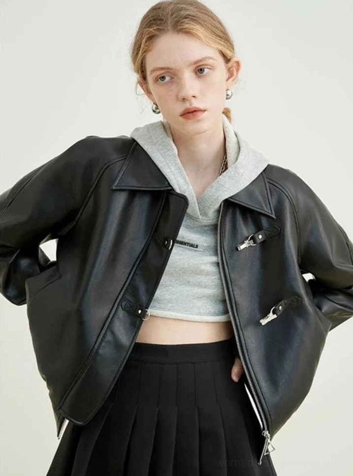 Side view of black faux leather cropped jacket showing notched lapel metal toggles and relaxed streetwear fit