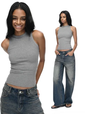 Black fitted crew neck racerback tank top front view styled with dark wash low rise jeans