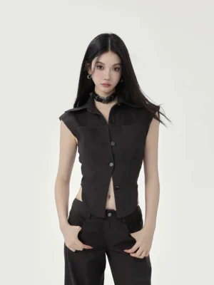 Front view of black fitted cropped button-up shirt with pointed collar curved hem and high-waist wide-leg pants
