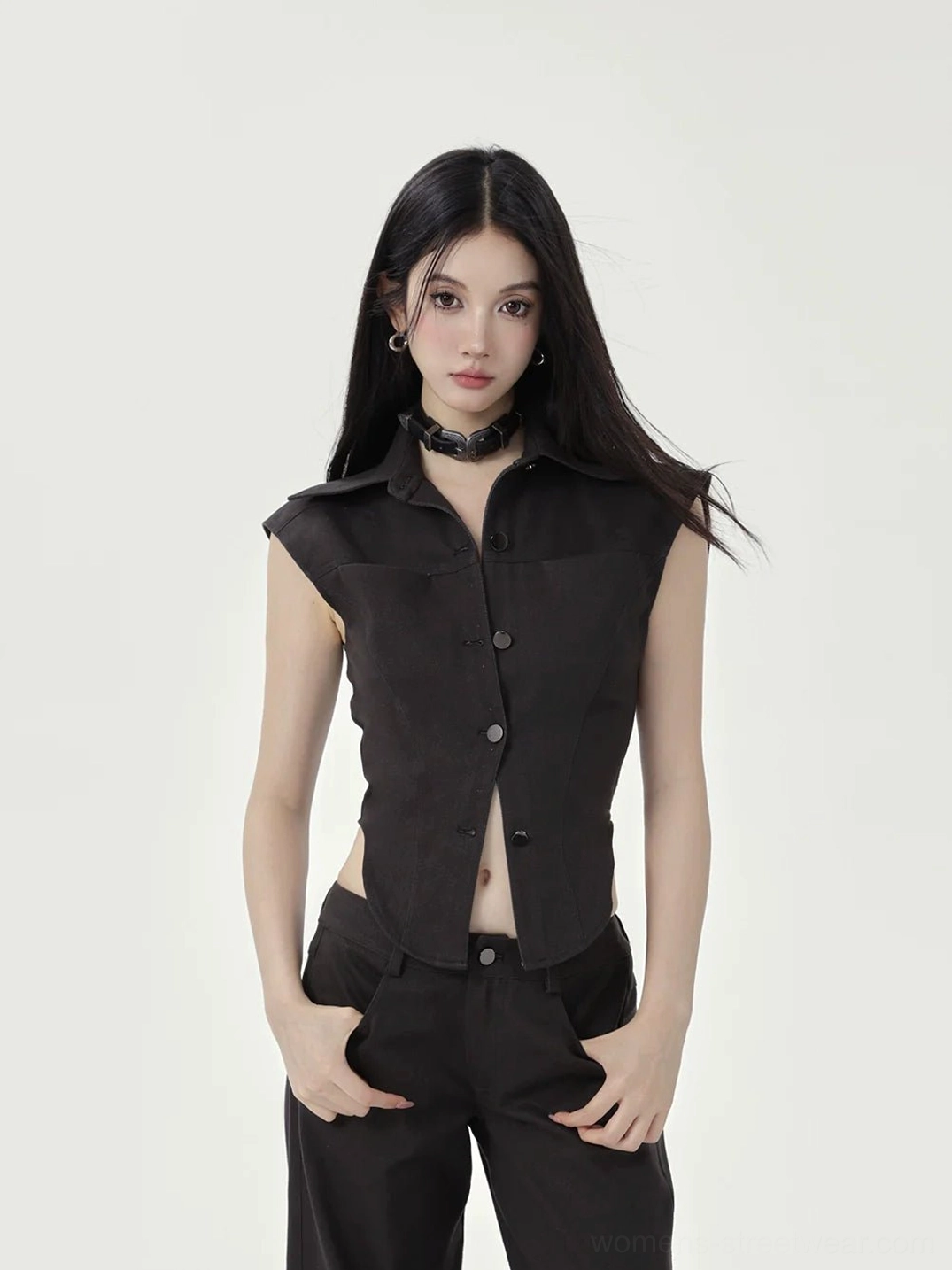 Front view of black fitted cropped button-up shirt with pointed collar curved hem and high-waist wide-leg pants