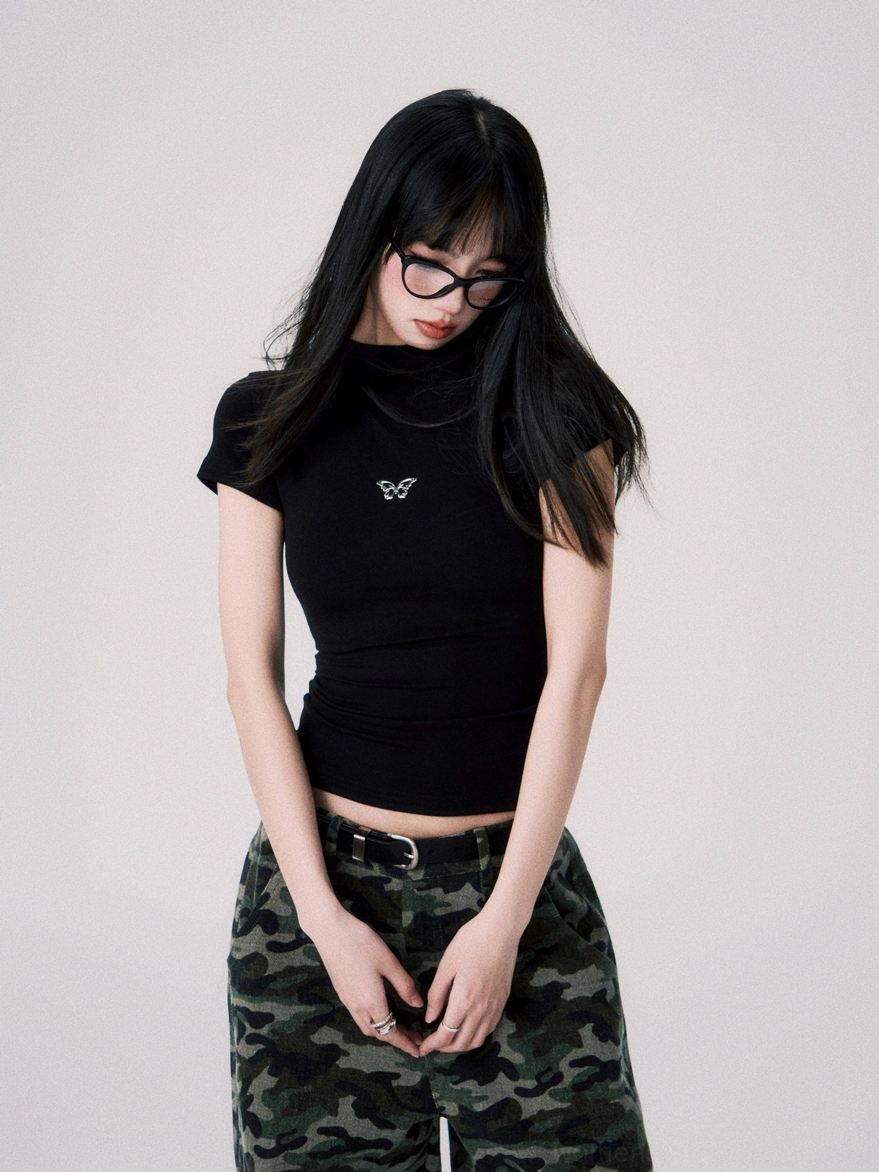 Black fitted cropped streetwear tee with delicate butterfly chest embroidery and leather waist belt