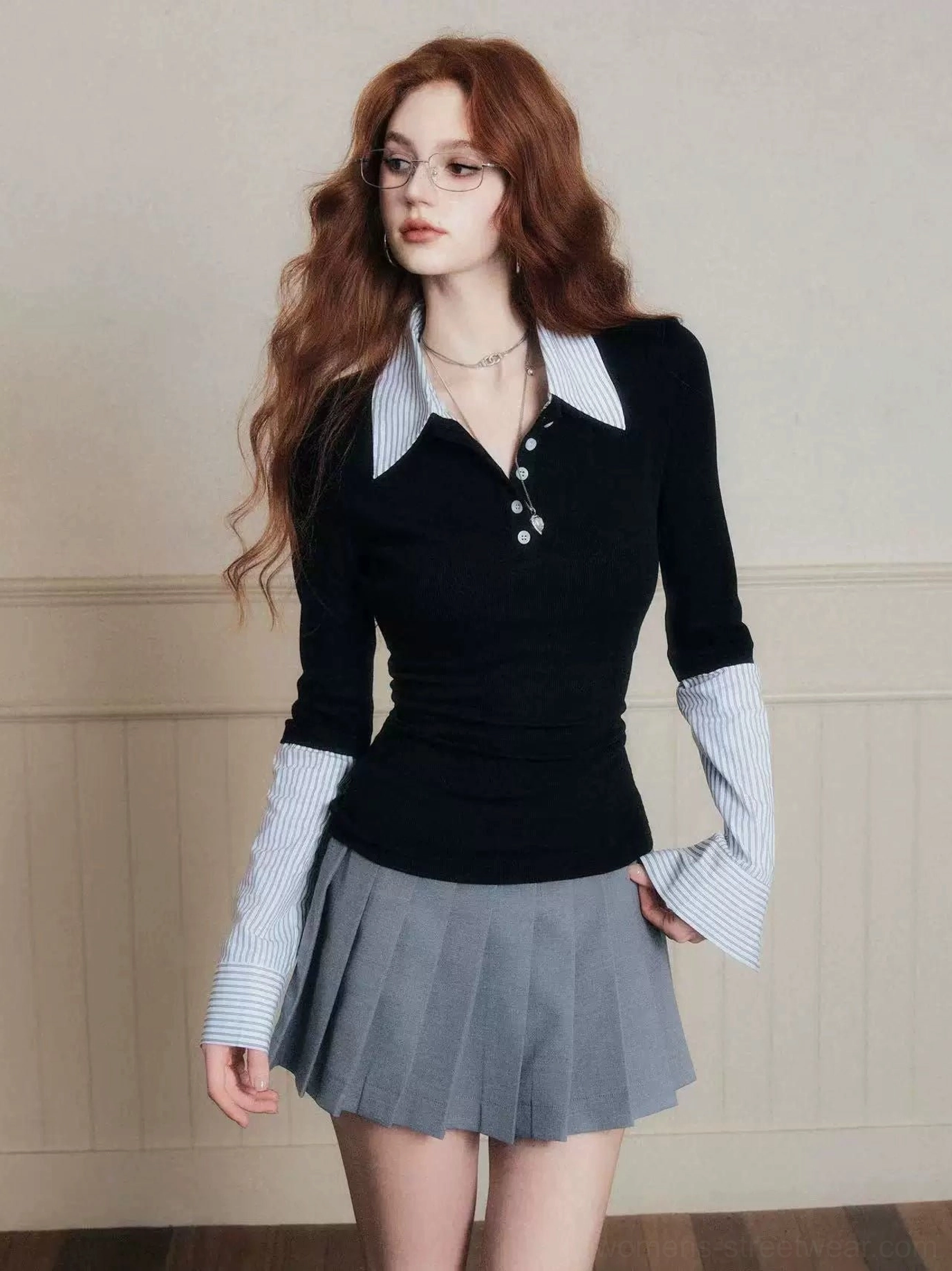 Black fitted layered polo top with contrast striped shirt collar and oversized cuffs front studio view