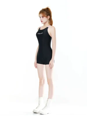 Side view of a fitted black one-piece sport swimsuit with slim lilac straps and tailored boyleg coverage