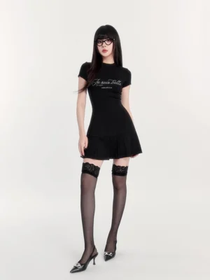 Black fitted pleated tennis dress full body view with sparkling chest slogan, short sleeves, and Korean Y2K streetwear styling