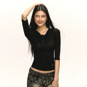 Black fitted ribbed Henley top with round neckline and front buttons styled with vintage low-rise studded jeans