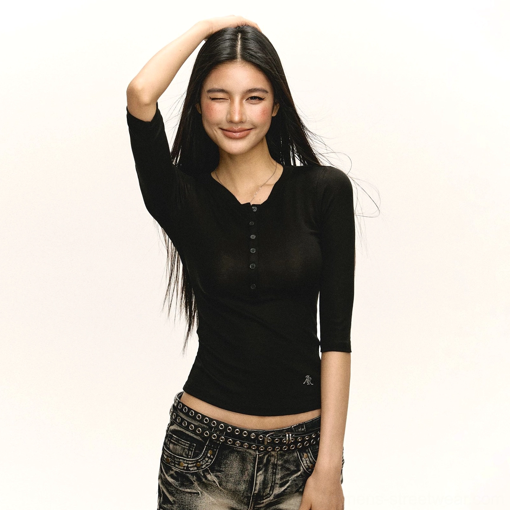 Black fitted ribbed Henley top with round neckline and front buttons styled with vintage low-rise studded jeans