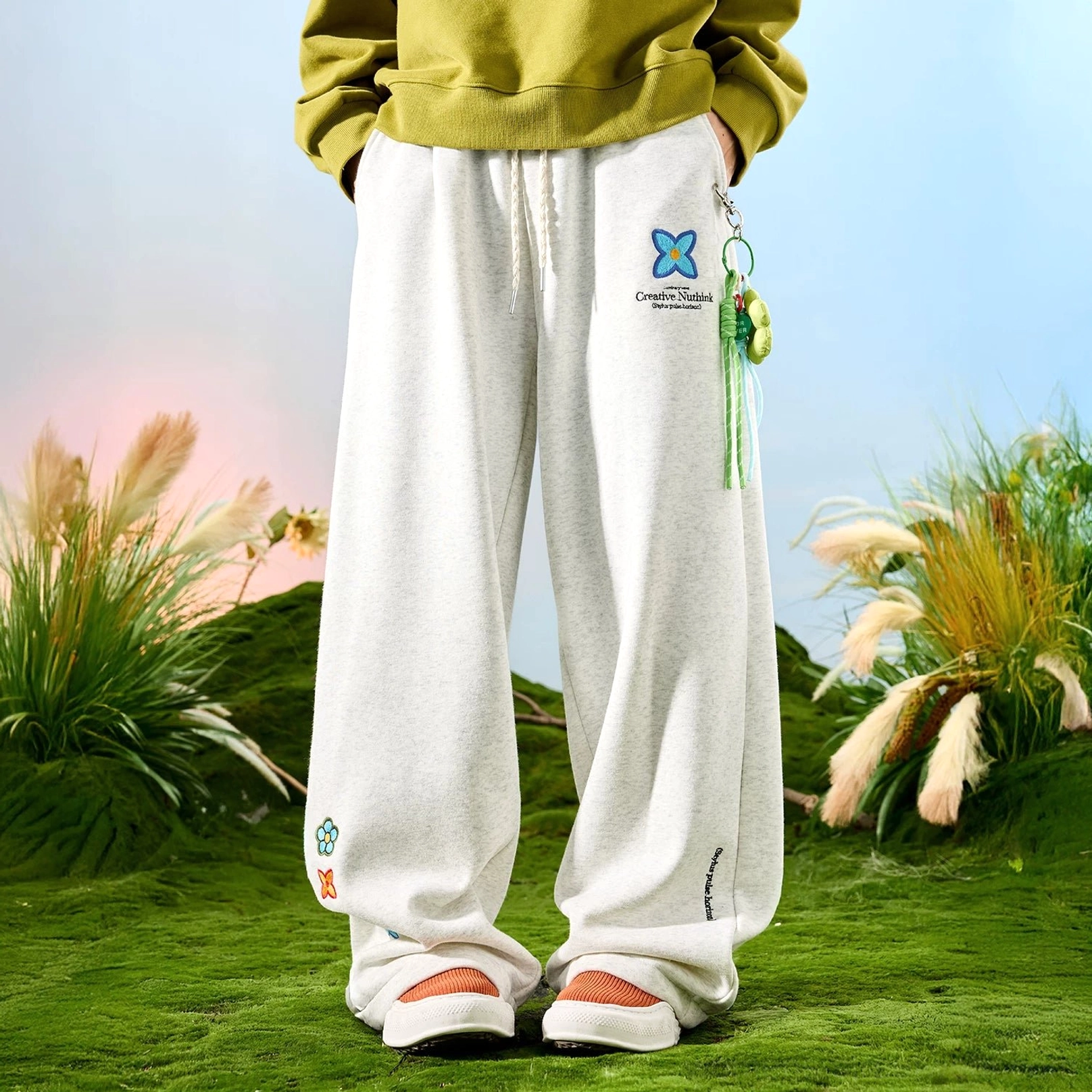 Black fleece-lined embroidered floral wide-leg sweatpants with relaxed oversized streetwear fit