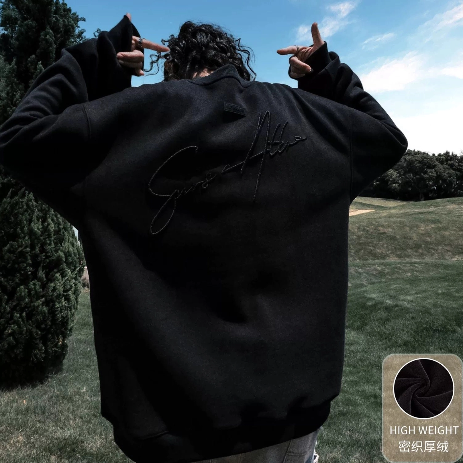 Black fleece-lined oversized script embroidered crewneck sweatshirt with a warm interior and relaxed streetwear fit