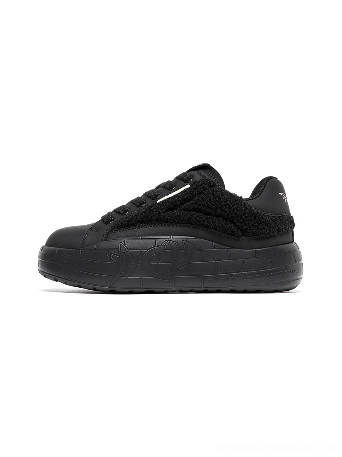 Black fleece-panel platform sneakers with plush shearling texture, matte toe caps, tonal laces, and embossed thick streetwear soles