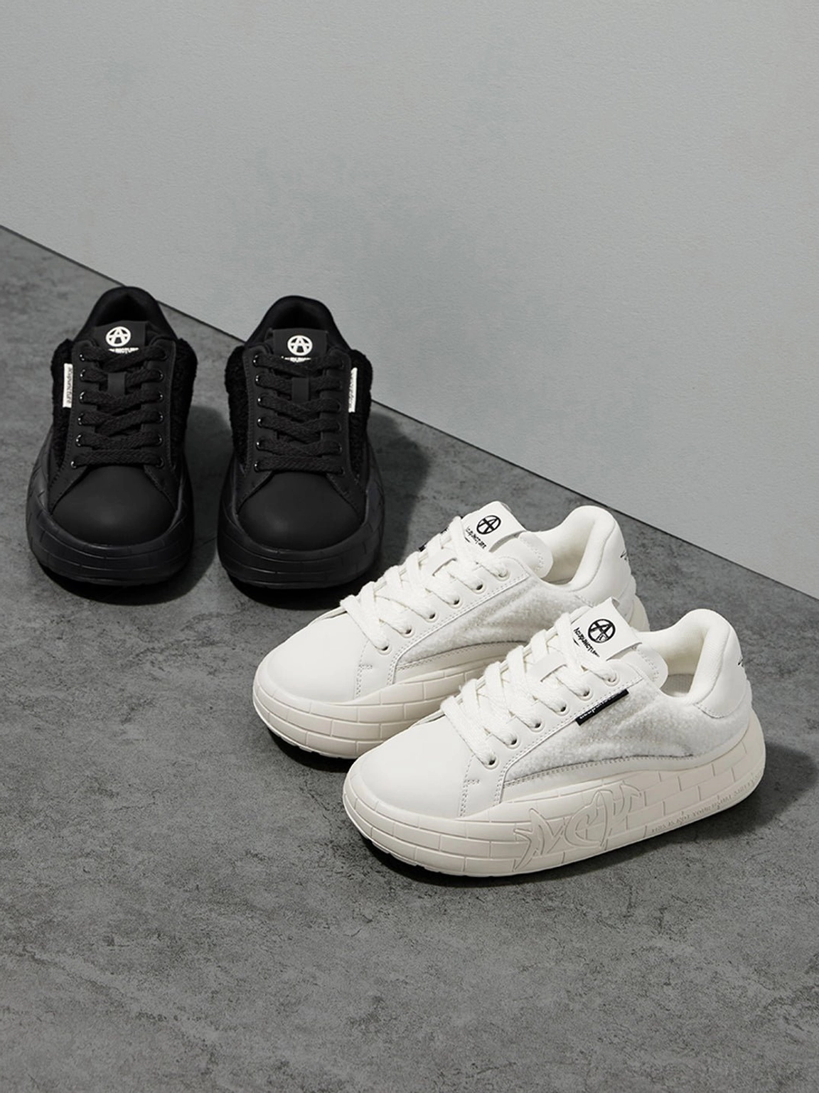 Black fleece-panel platform trainers with soft upper texture and sculpted sole for casual everyday wear