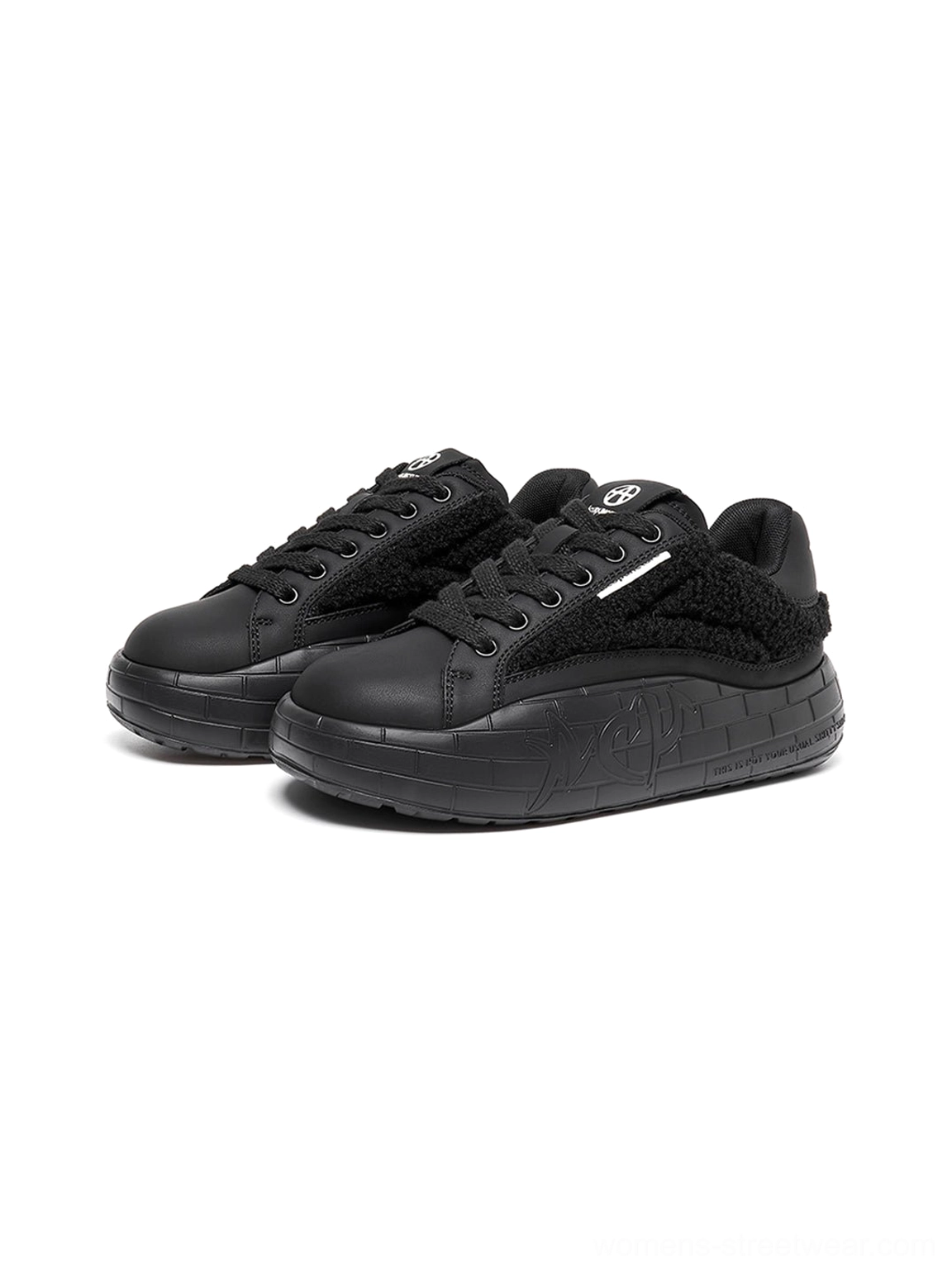 Side-by-side black fleece-panel sneakers with fuzzy upper texture, white lace accents, and chunky platform soles